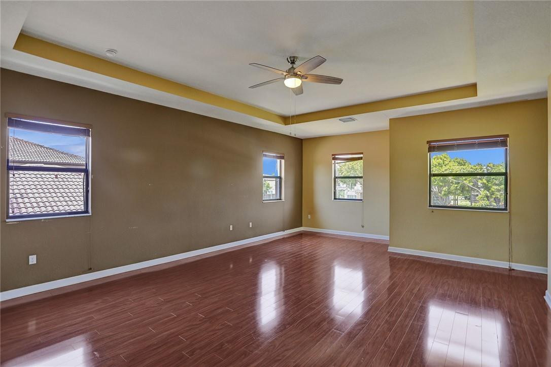 11331 Southwest 240 Lane Homestead, FL 33032 - Photo 37 of 92 a view of an empty room with window and wooden floor