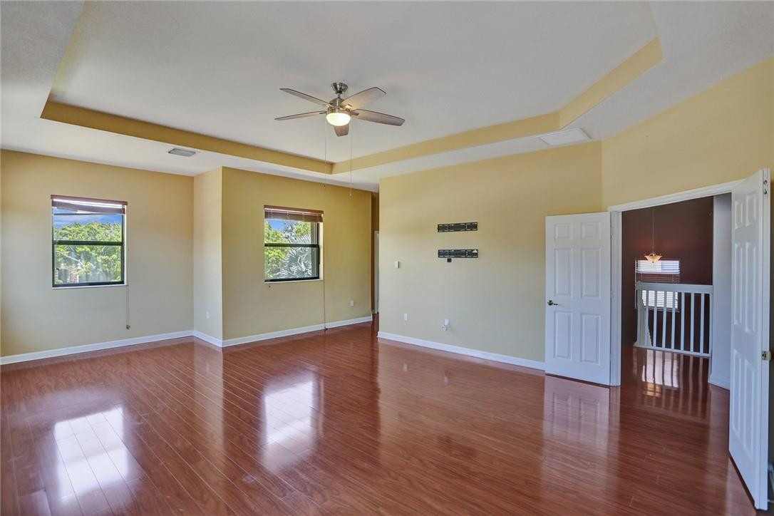 11331 Southwest 240 Lane Homestead, FL 33032 - Photo 39 of 92 a view of an hallway with wooden floor and a ceiling fan