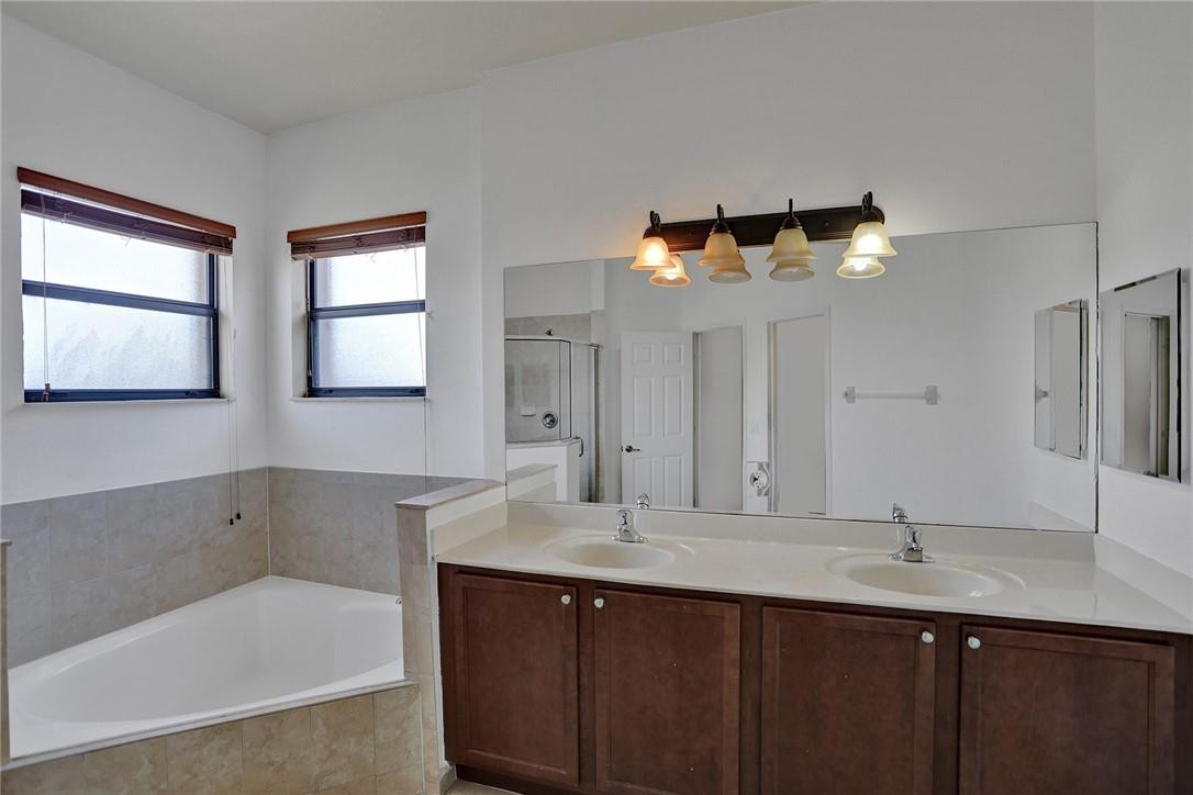 11331 Southwest 240 Lane Homestead, FL 33032 - Photo 46 of 92 a bathroom with a tub a sink and mirror