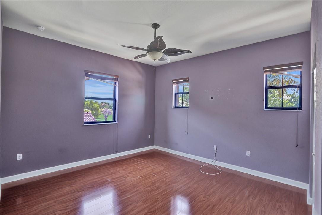 11331 Southwest 240 Lane Homestead, FL 33032 - Photo 57 of 92 a view of an empty room with a window and wooden floor