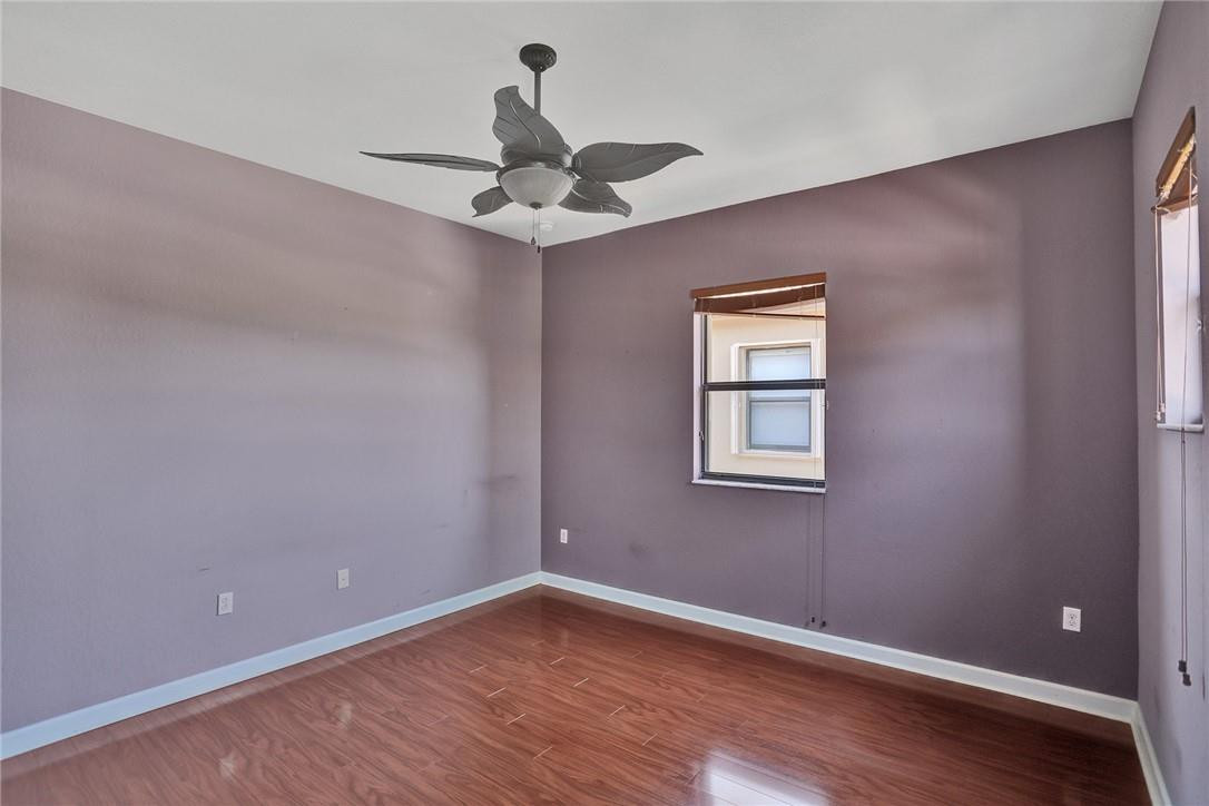 11331 Southwest 240 Lane Homestead, FL 33032 - Photo 58 of 92 a view of an empty room with wooden floor and a window