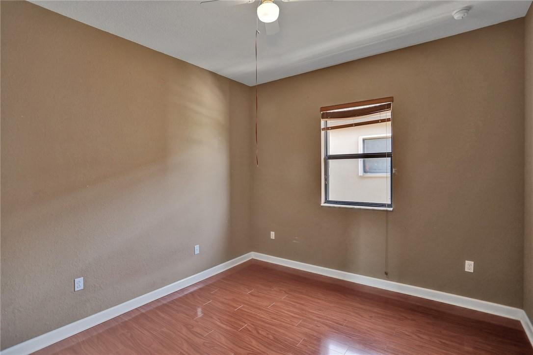 11331 Southwest 240 Lane Homestead, FL 33032 - Photo 60 of 92 a view of an empty room with wooden floor and a window