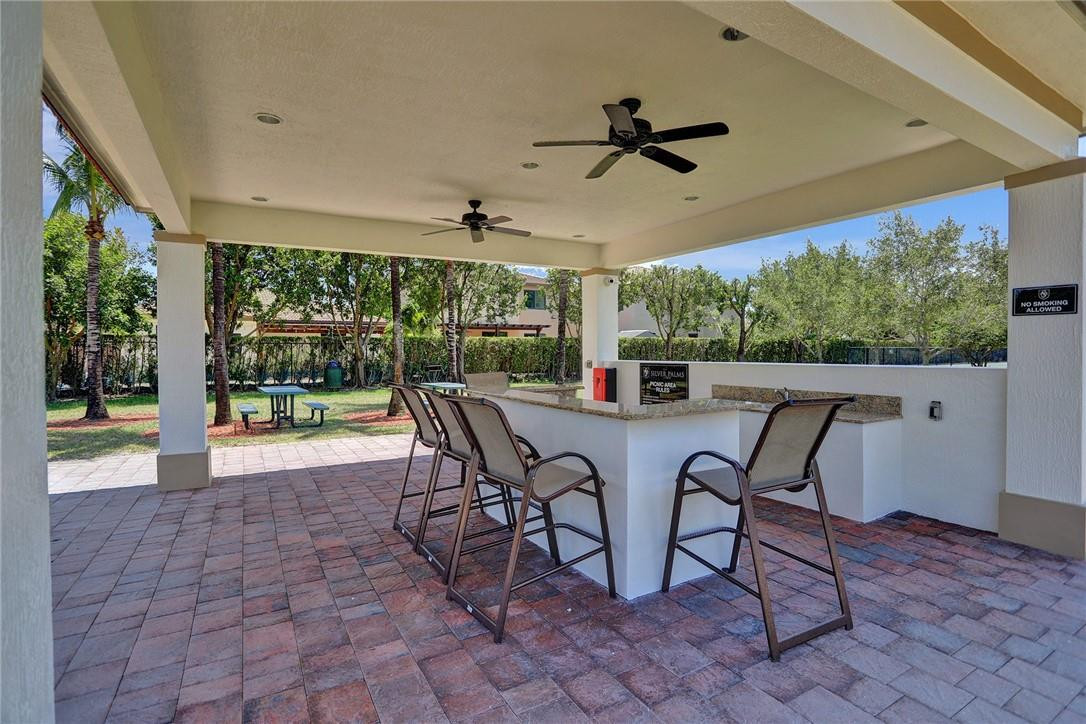 11331 Southwest 240 Lane Homestead, FL 33032 - Photo 75 of 92 a dining room with furniture and a floor to ceiling window