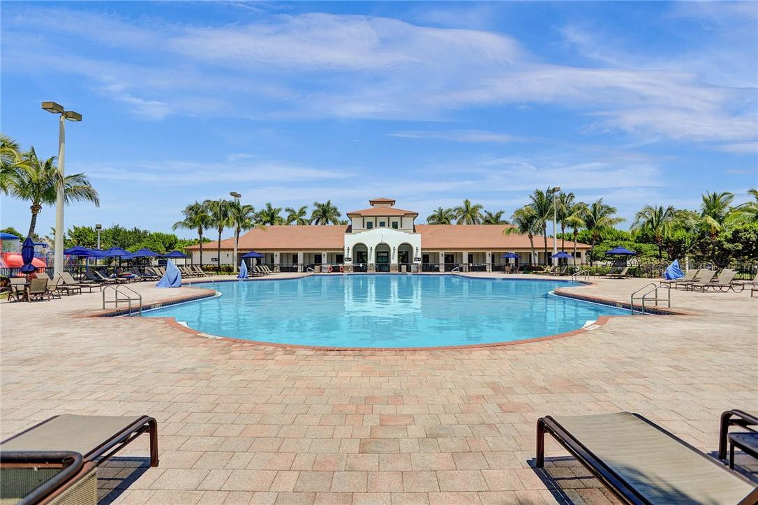11331 Southwest 240 Lane Homestead, FL 33032 - Photo 82 of 92 a view of a swimming pool with a lawn chairs and a fire pit