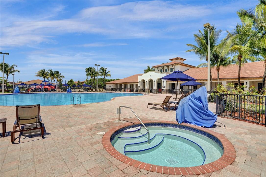 11331 Southwest 240 Lane Homestead, FL 33032 - Photo 88 of 92 a swimming pool with outdoor seating and outdoor seating