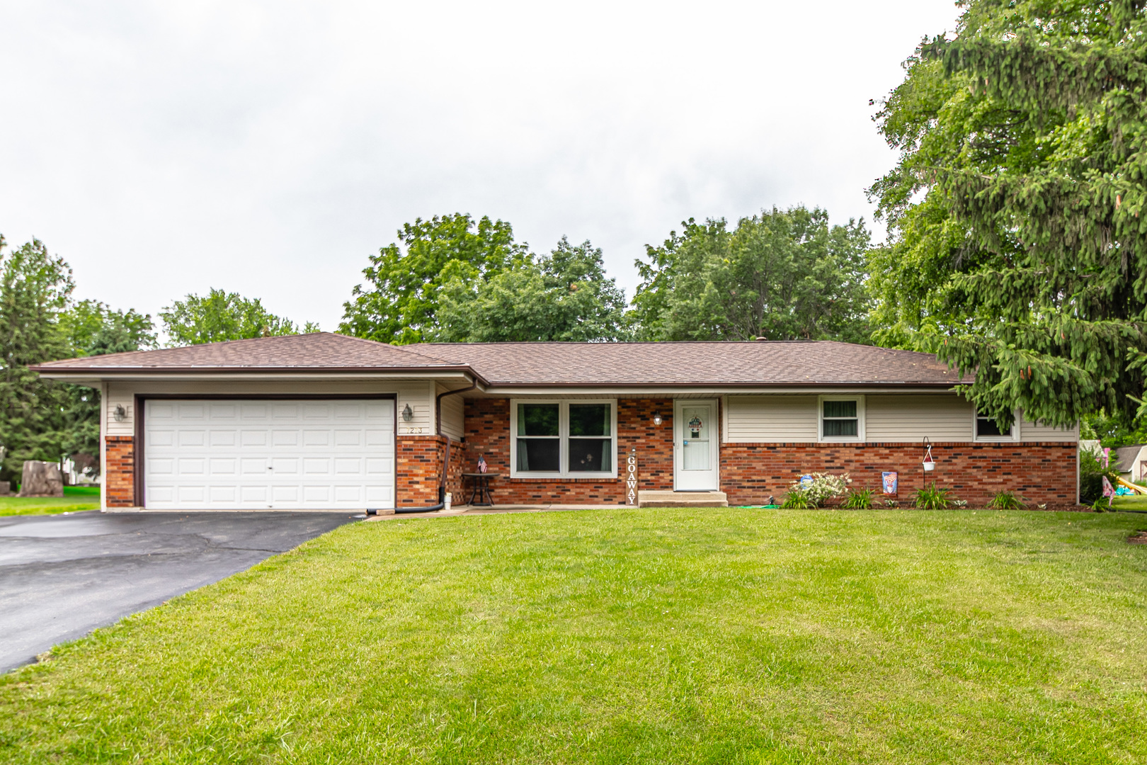 a front view of house with yard and green space
