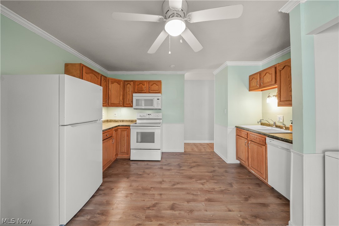 3796 North Santom Road Stow, OH 44224 - Photo 6 of 30 Kitchen featuring wood-finish flooring, wood cabinetry, white appliances, and a ceiling fan with light fixture