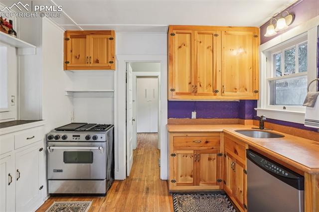 Kitchen with gas stove, plenty of cabinet space, movable island and wood flooring