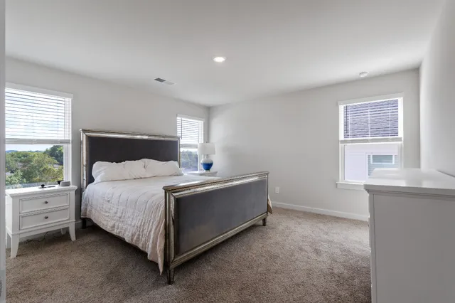a spacious bedroom with a bed and window
