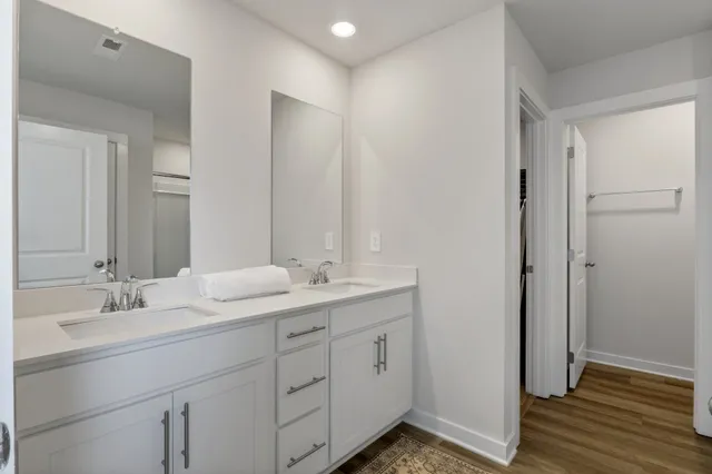 a bathroom with a double vanity sink and mirror