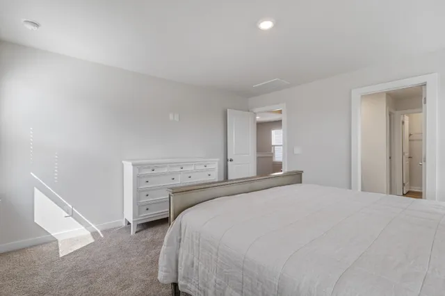 a bedroom with a bed and a large mirror