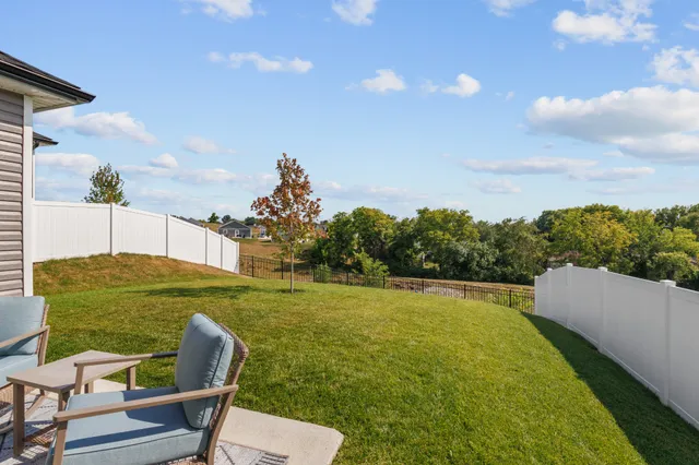 a backyard of a house with table and chairs