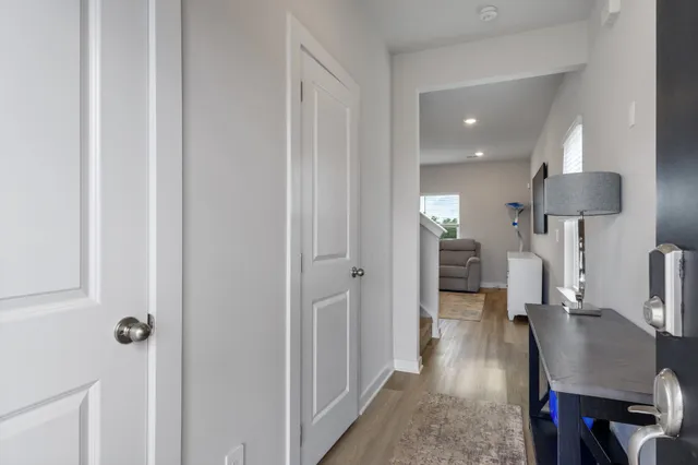 a view of a room with wooden floor table and chairs