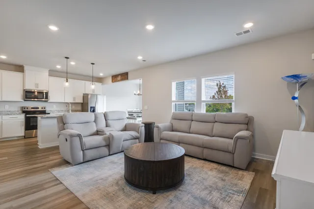 a living room with furniture and a large window