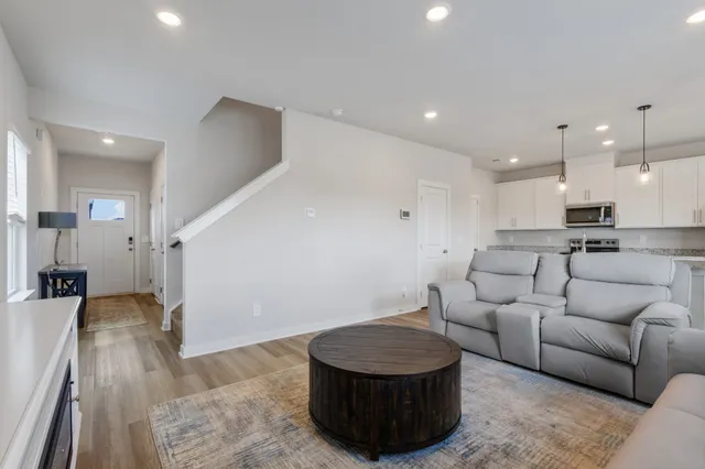 a living room with furniture and a wooden floor