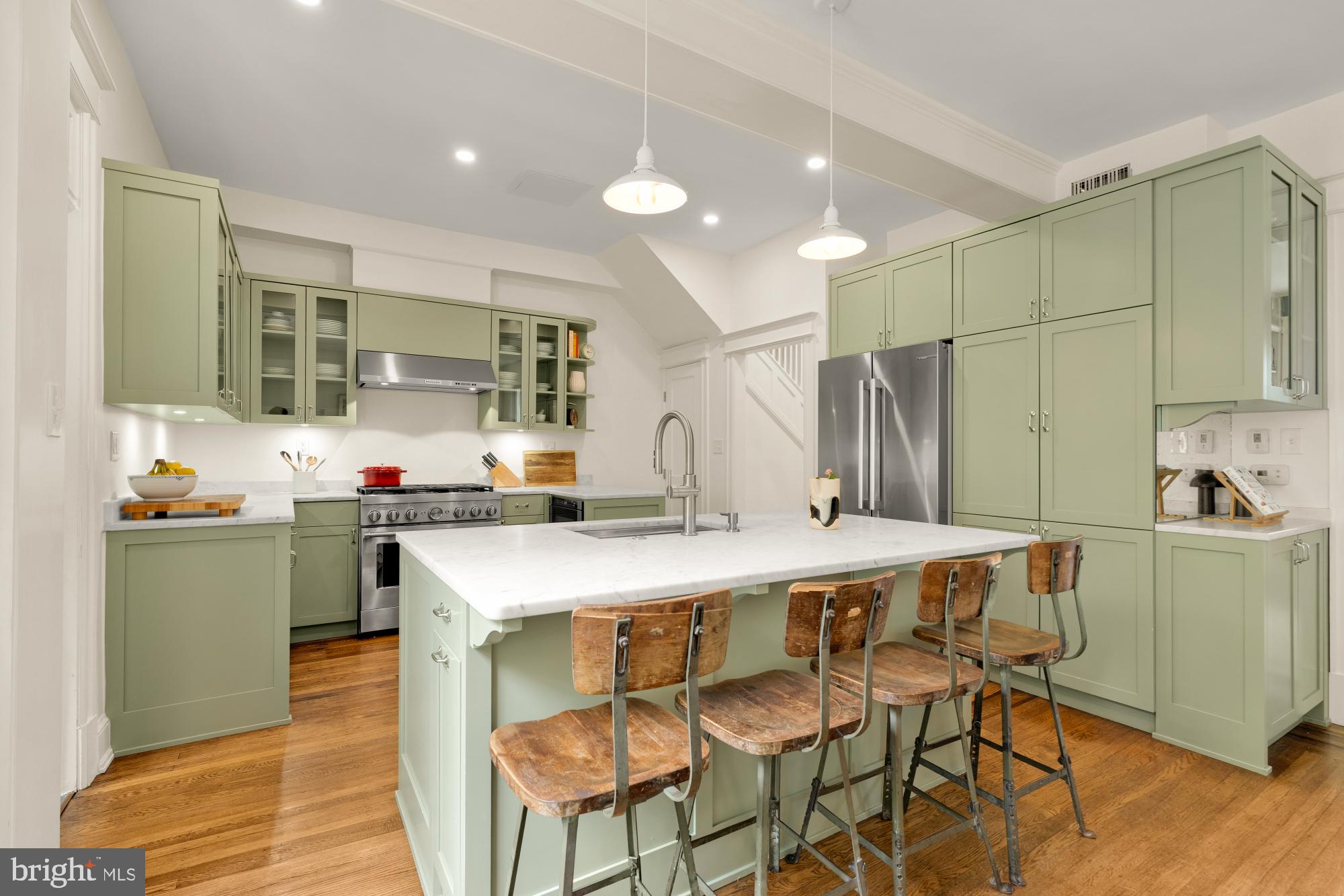 1929 Park Road Northwest Washington, DC 20010 - Photo 12 of 54 a kitchen with stainless steel appliances a table chairs and a refrigerator