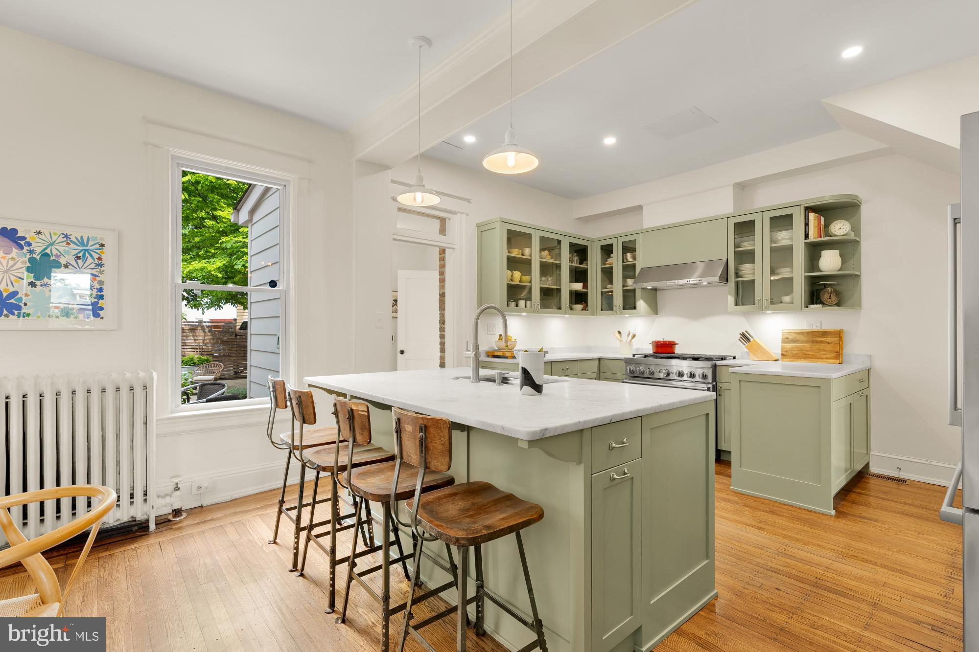 1929 Park Road Northwest Washington, DC 20010 - Photo 14 of 54 a kitchen with stainless steel appliances kitchen island granite countertop a sink and cabinets
