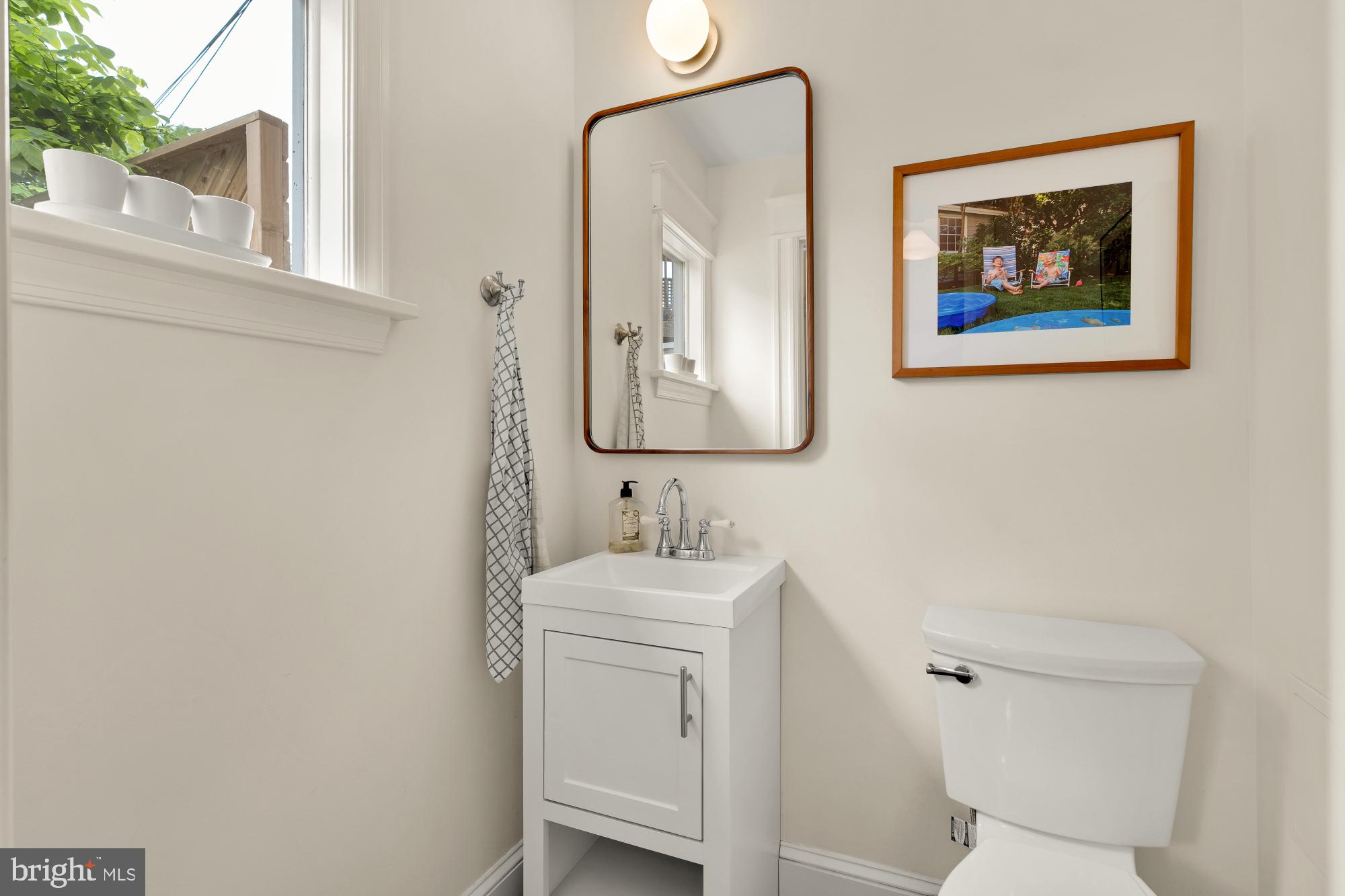 1929 Park Road Northwest Washington, DC 20010 - Photo 18 of 54 a bathroom with a toilet a sink and mirror