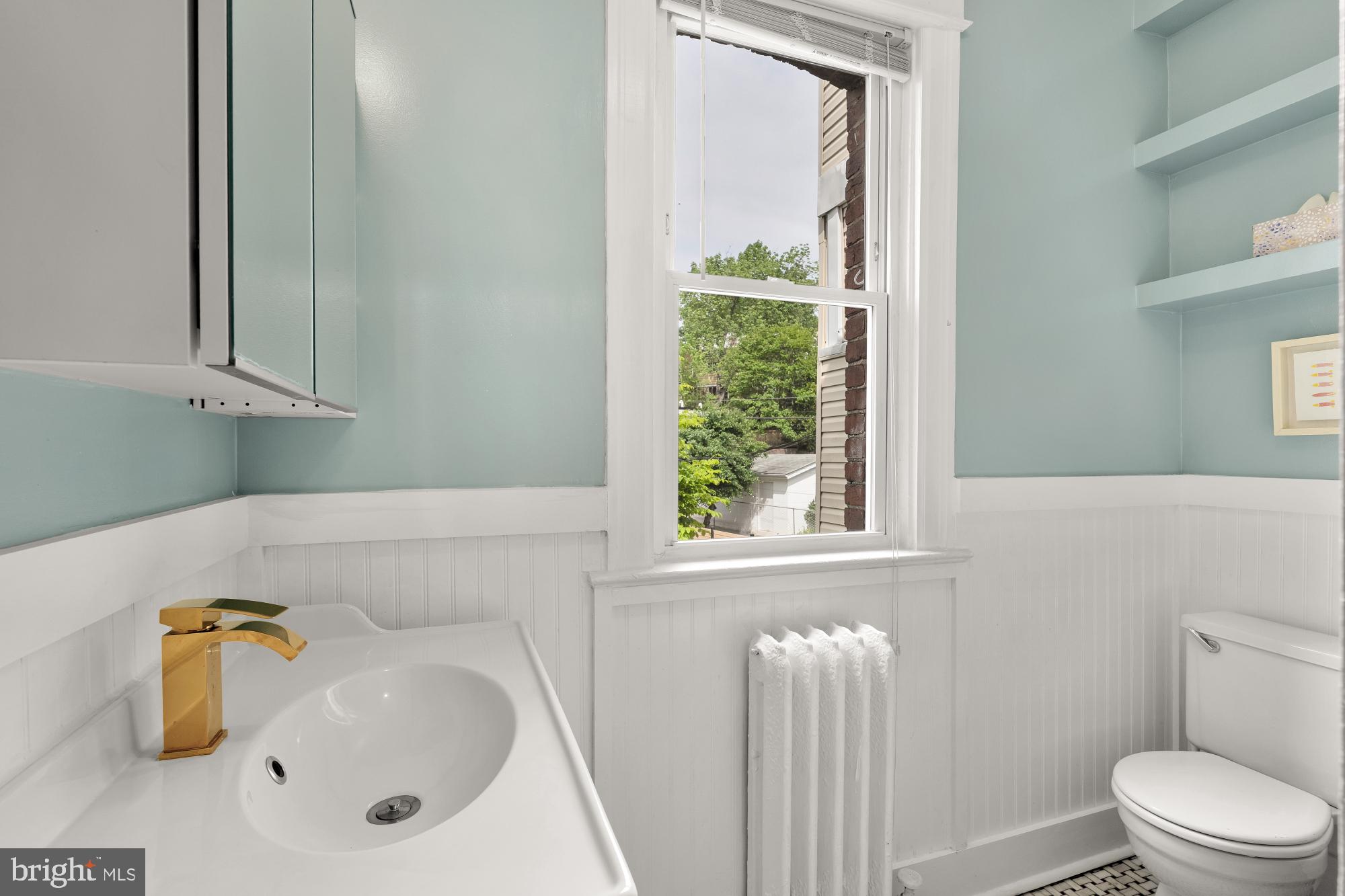 1929 Park Road Northwest Washington, DC 20010 - Photo 26 of 54 a bathroom with a sink a toilet and a window