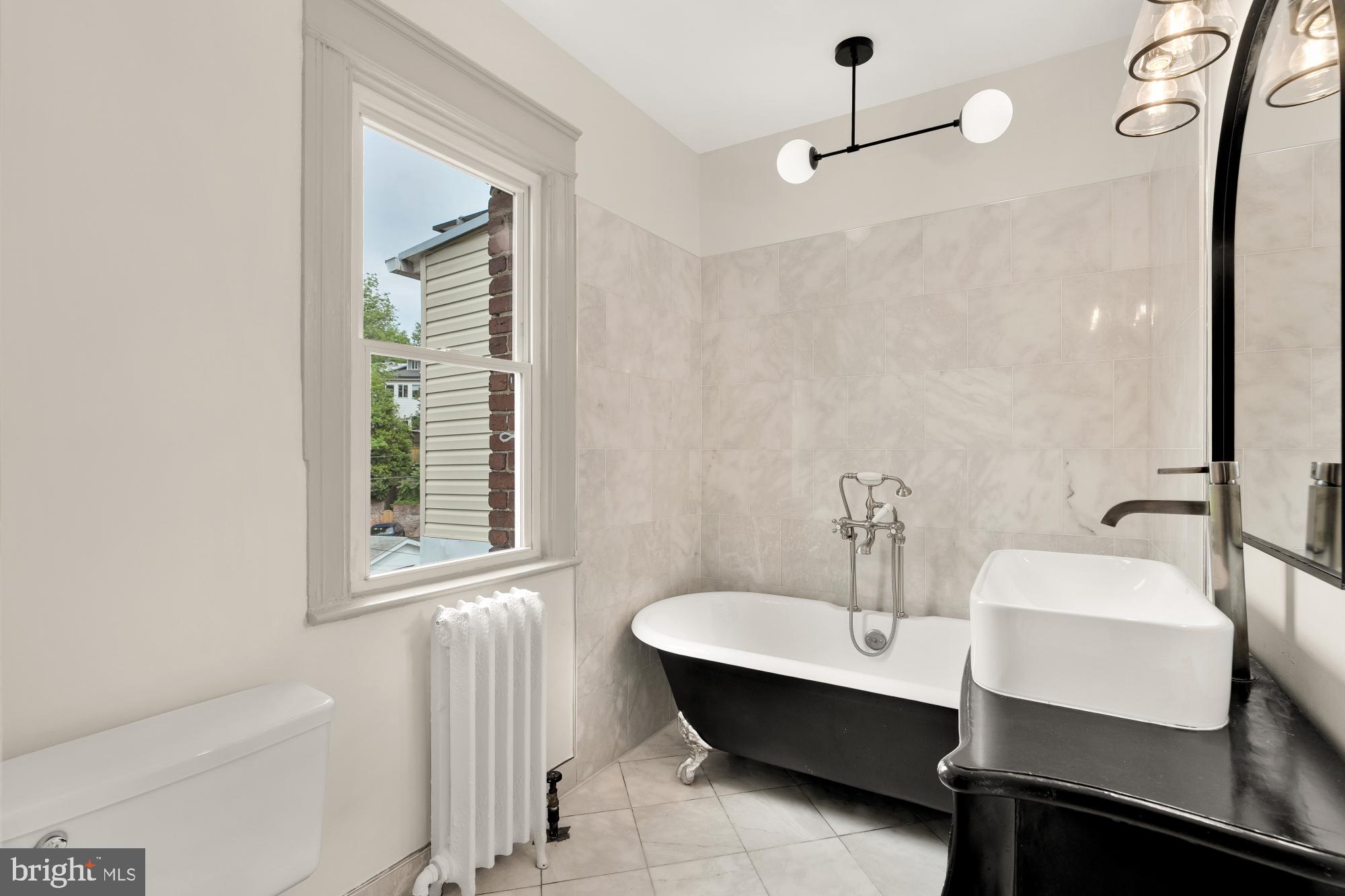 1929 Park Road Northwest Washington, DC 20010 - Photo 32 of 54 a bathroom with a sink and a mirror