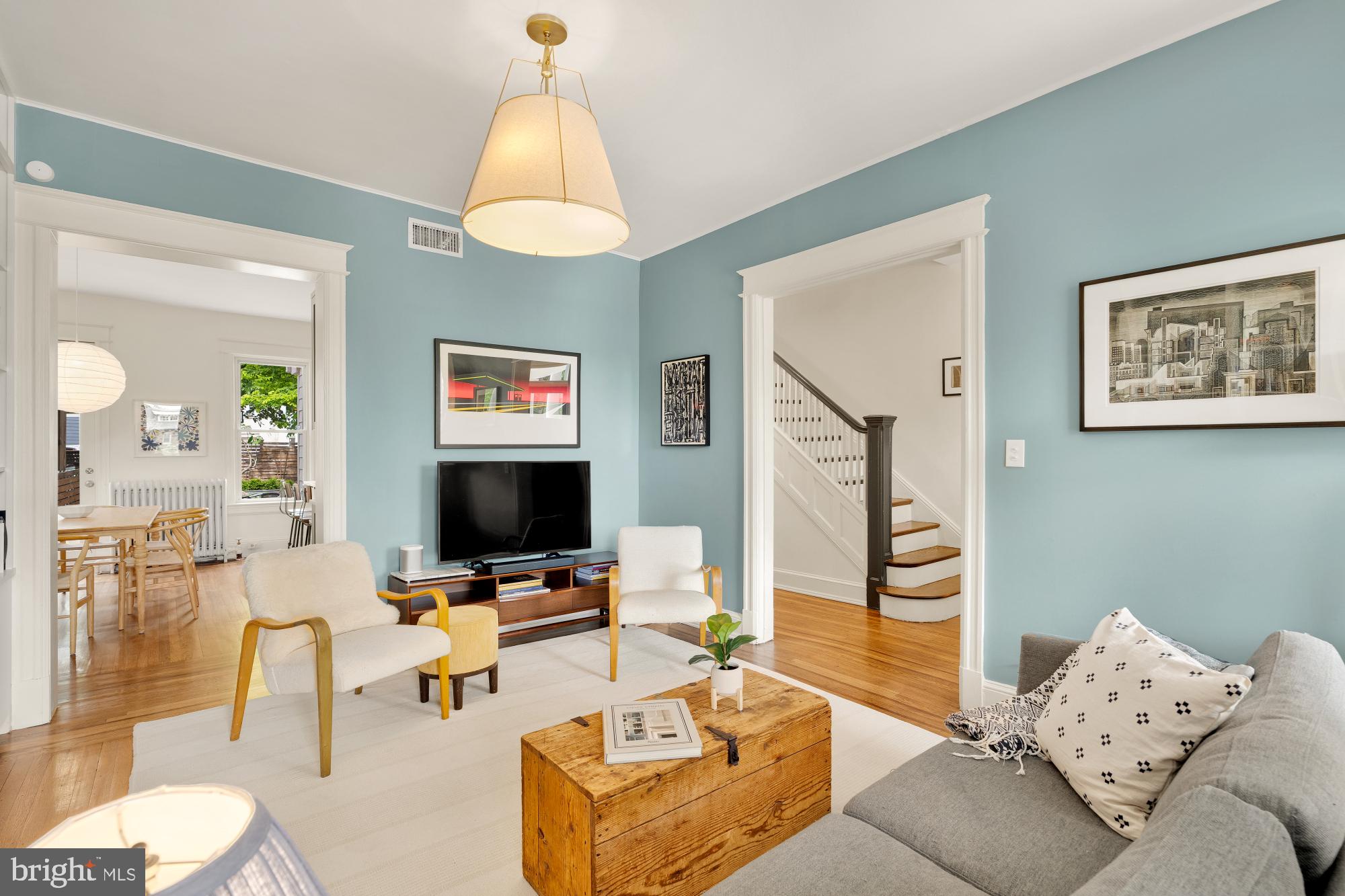 1929 Park Road Northwest Washington, DC 20010 - Photo 7 of 54 a living room with furniture a chandelier and a flat screen tv