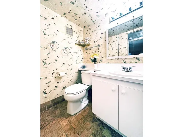 a bathroom with a sink toilet and mirror