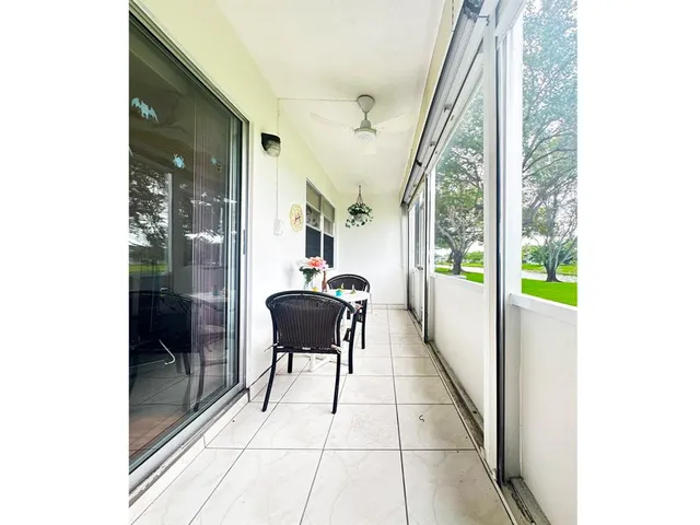 a view of swimming pool with outdoor seating and a yard