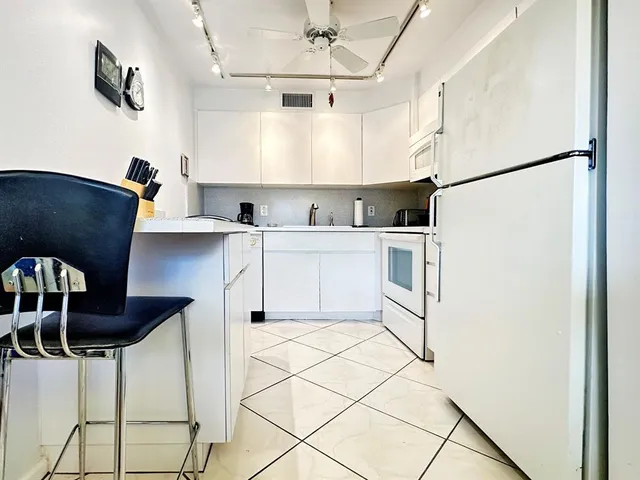 a kitchen with stainless steel appliances a refrigerator sink and cabinets