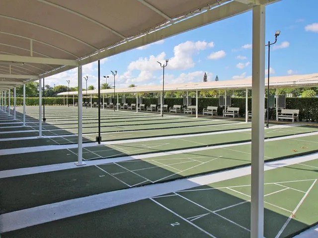a living room with furniture and large windows