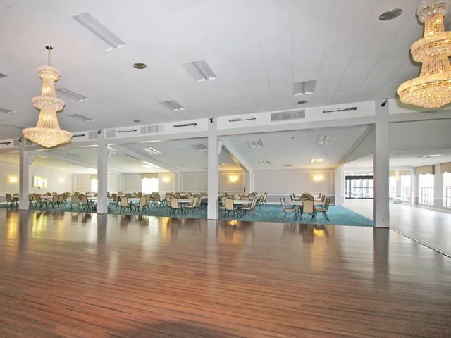 a living room with furniture kitchen view and a large window