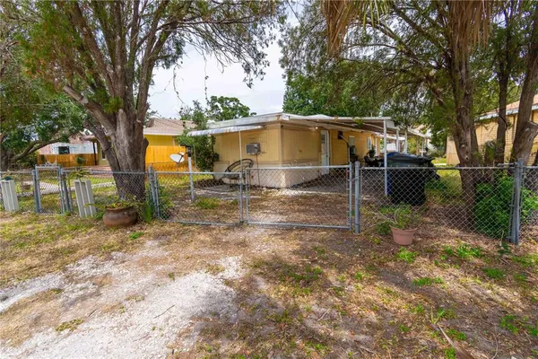 a backyard of a house with table and chairs