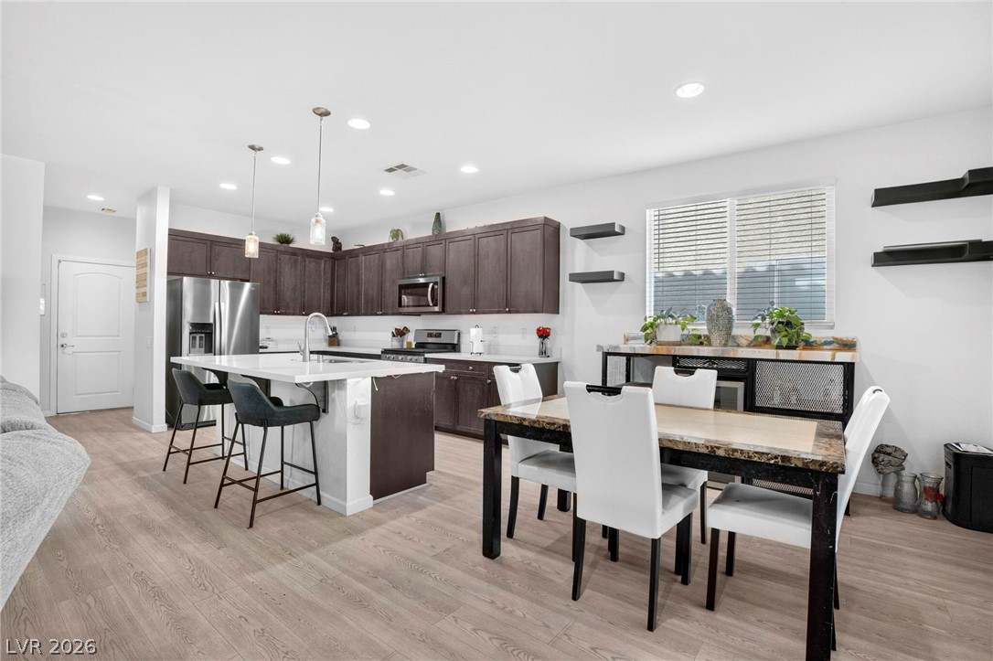 6281 Angora Peak Lane Las Vegas, NV 89115 - Photo 11 of 34 Culinary excellence awaits in this modern kitchen, featuring an eat-in island and rich cabinetry.