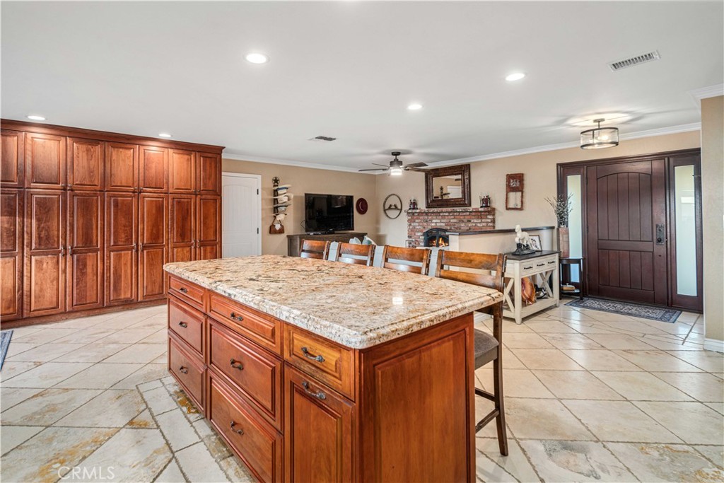 2862 Calmgarden Road Acton, CA 93510 - Photo 12 of 69 a kitchen with stainless steel appliances granite countertop a table chairs sink and cabinets