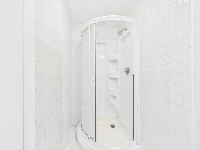 a bathroom with a glass shower door