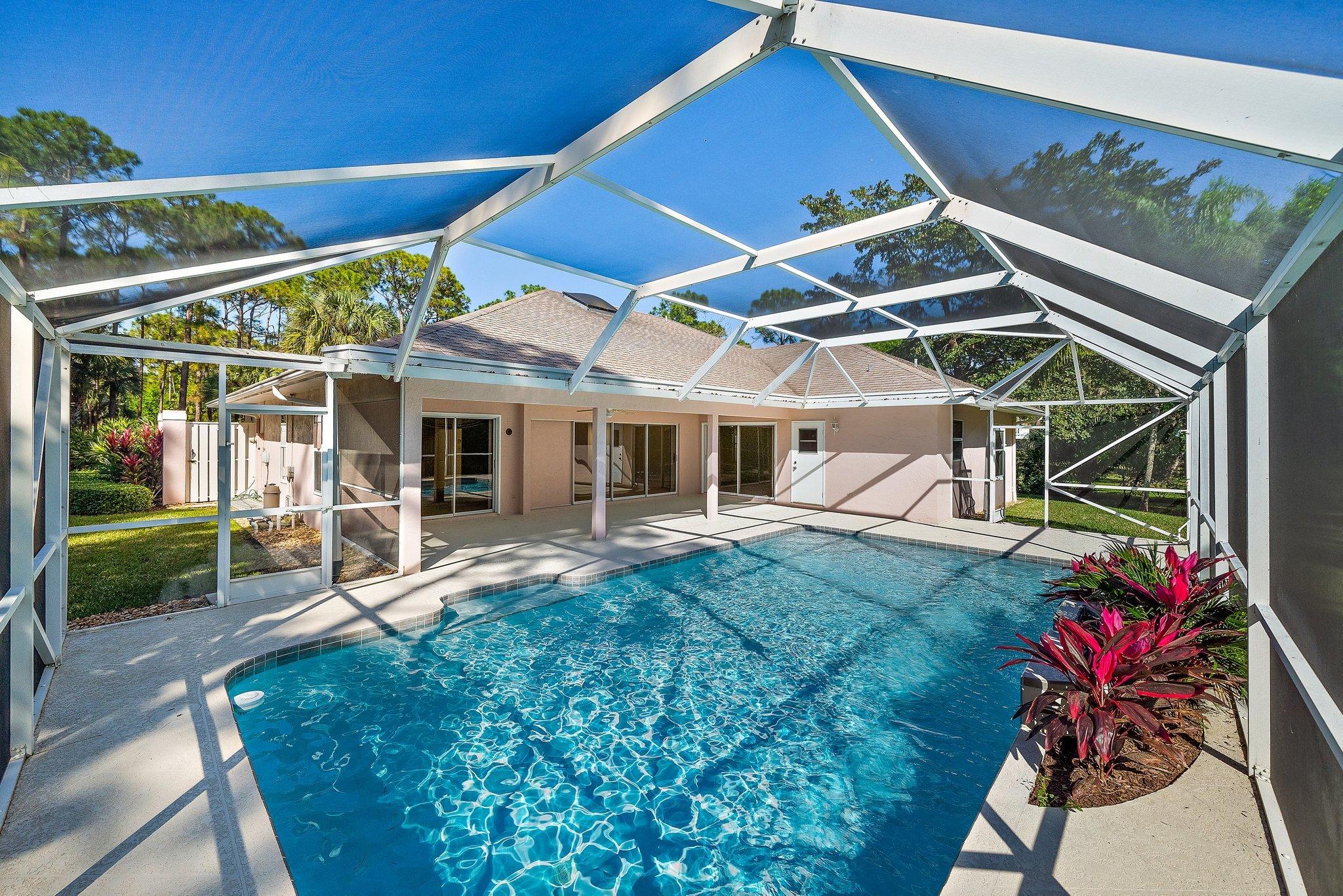 10424 Sandy Run Road Jupiter, FL 33478 - Photo 2 of 52 a view of a house with backyard porch and sitting area