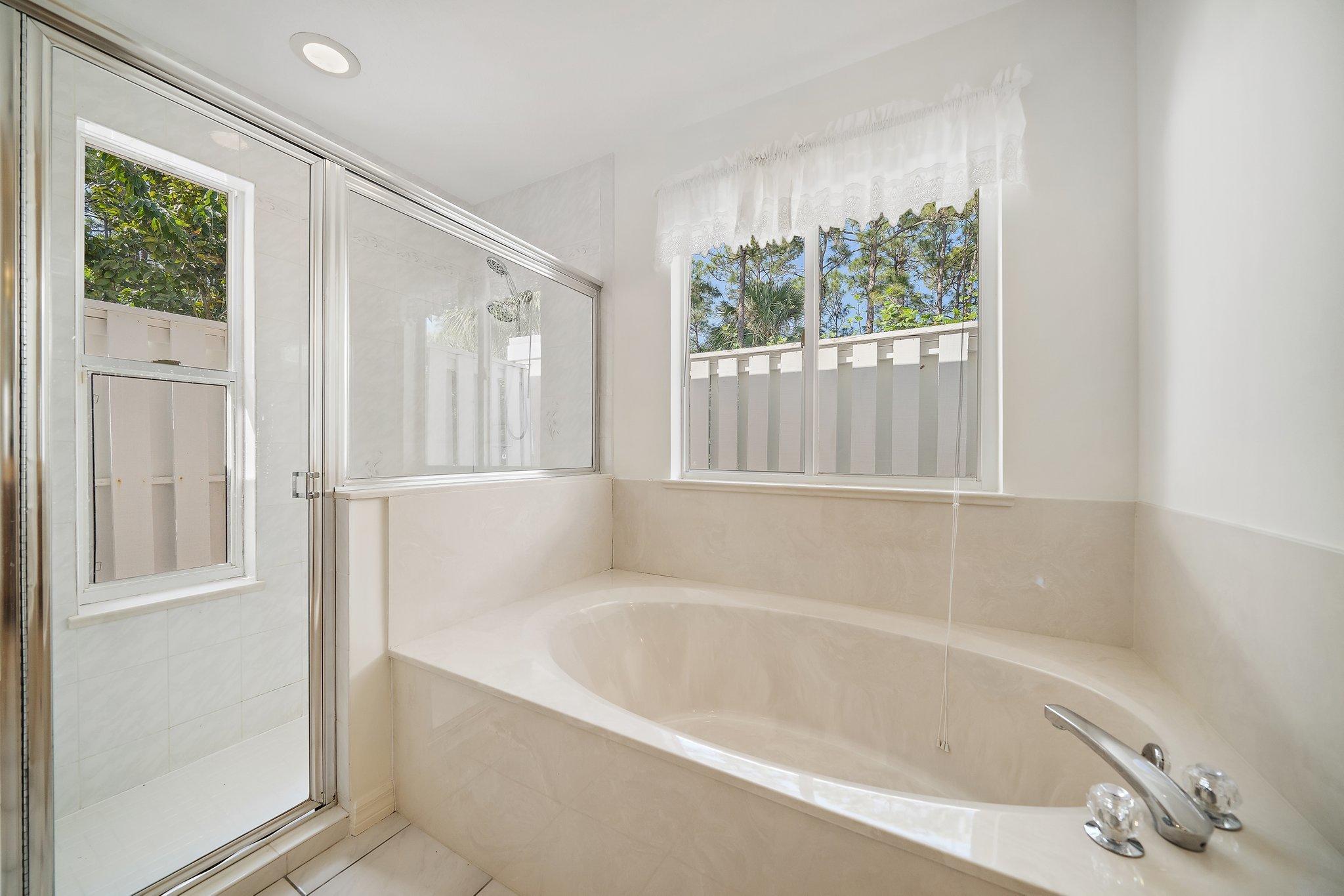 10424 Sandy Run Road Jupiter, FL 33478 - Photo 12 of 52 a white bath tub sitting next to a window