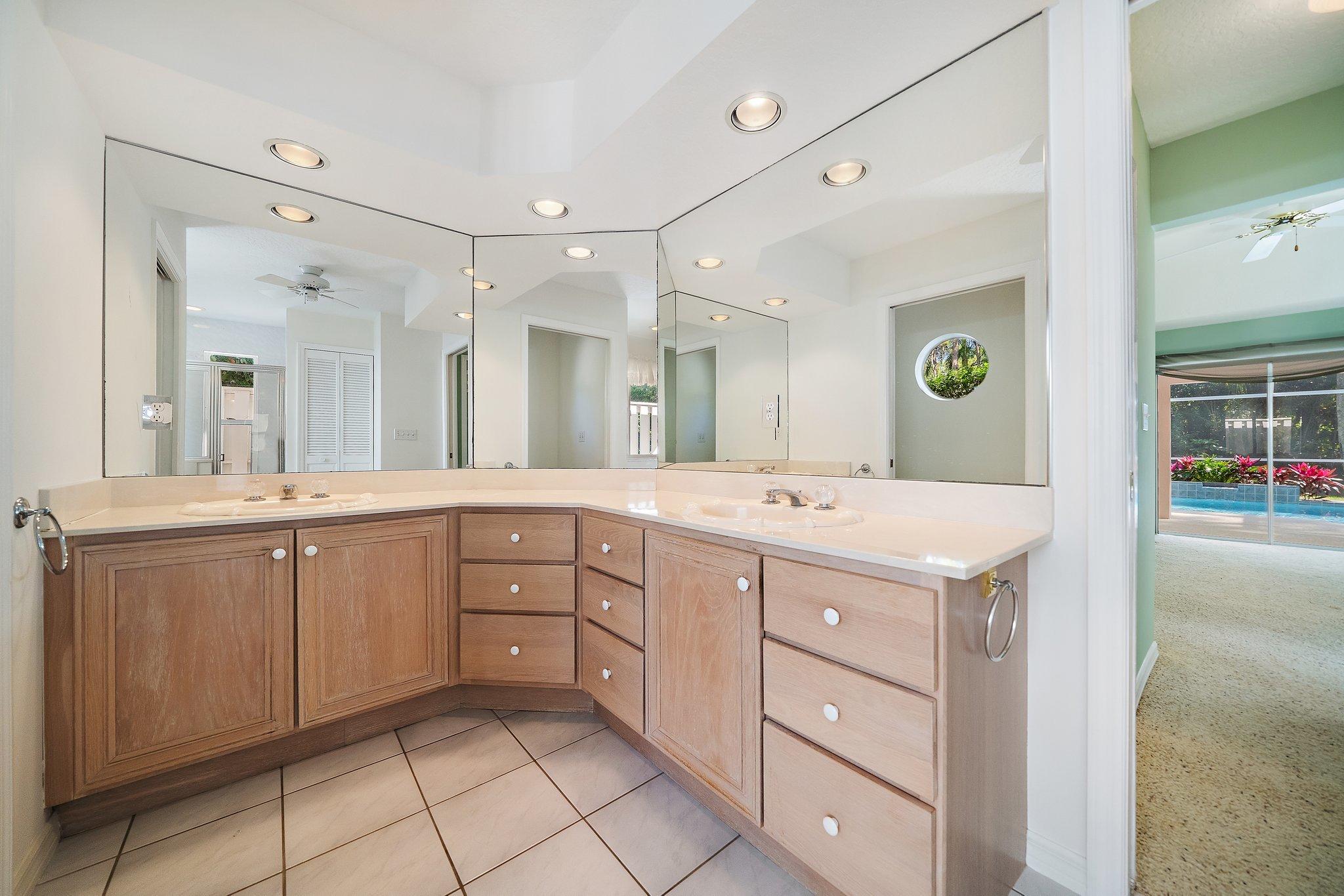 10424 Sandy Run Road Jupiter, FL 33478 - Photo 14 of 52 a spacious bathroom with a granite countertop sink mirror and shower