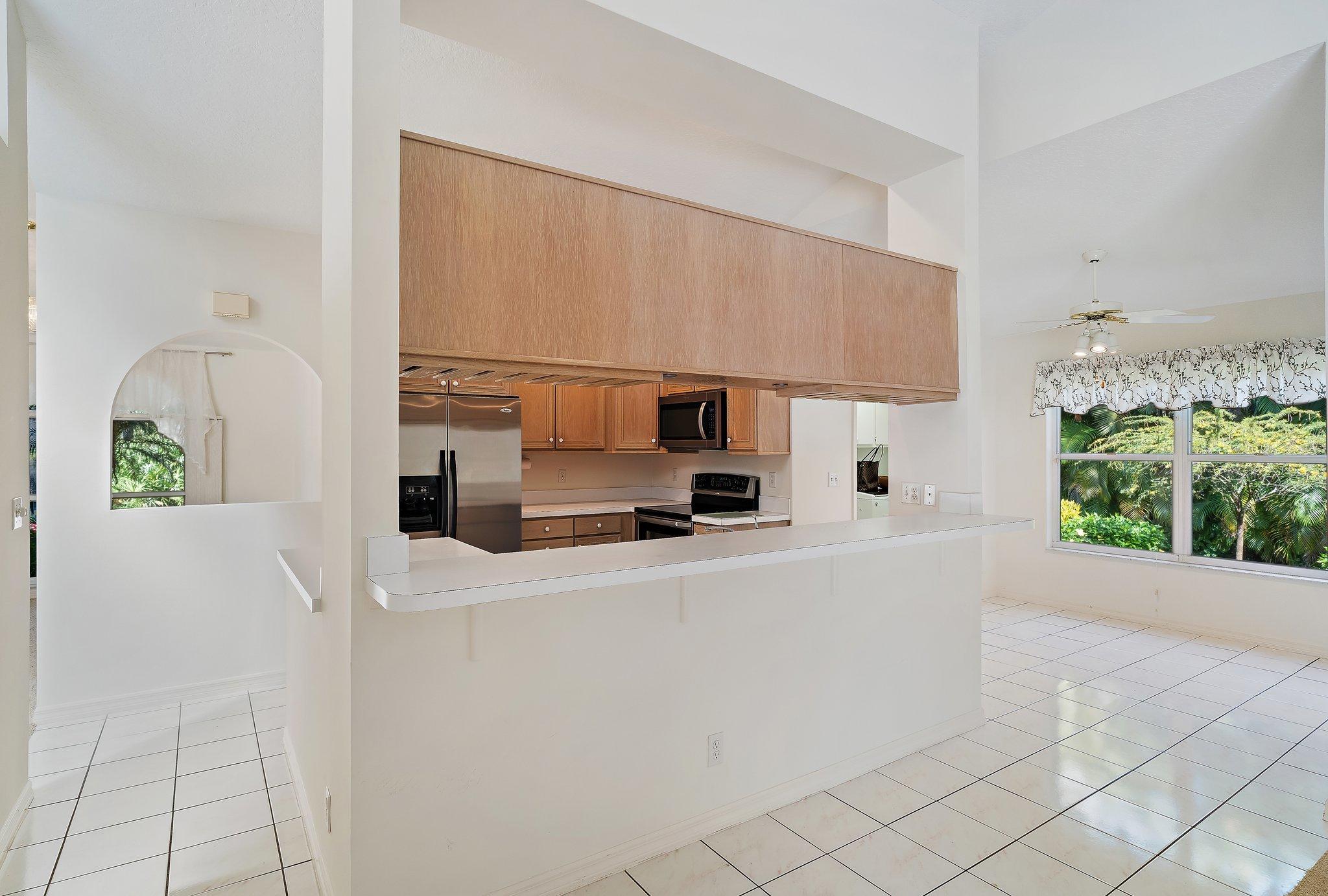 10424 Sandy Run Road Jupiter, FL 33478 - Photo 19 of 52 a kitchen with stainless steel appliances a sink and a refrigerator