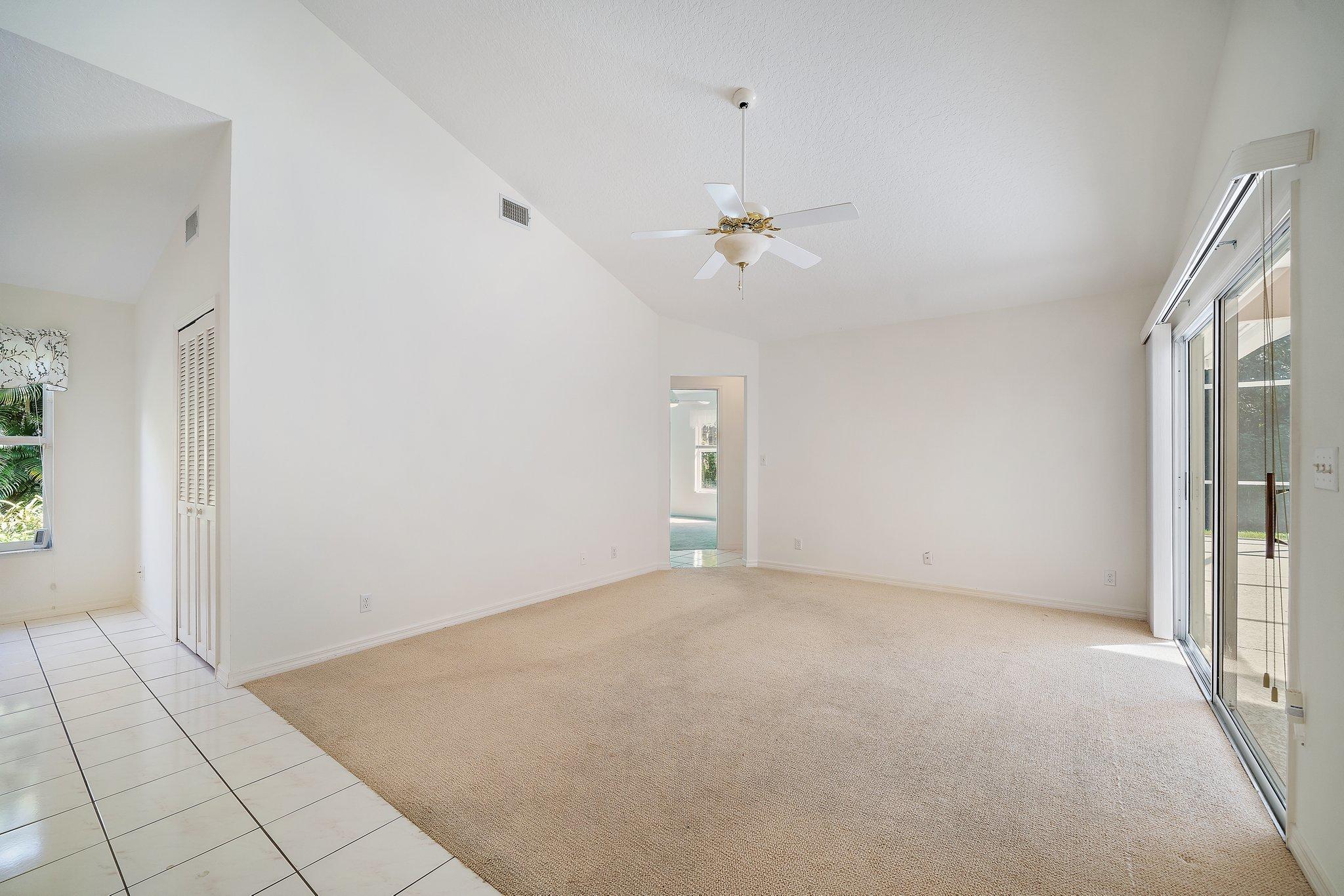 10424 Sandy Run Road Jupiter, FL 33478 - Photo 20 of 52 wooden floor in an empty room with a window