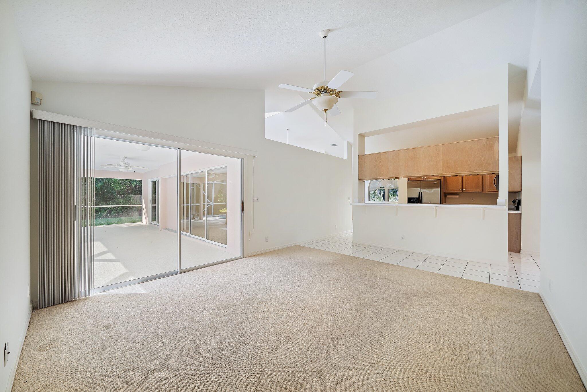 10424 Sandy Run Road Jupiter, FL 33478 - Photo 22 of 52 a view of a big room with windows and chandelier fan