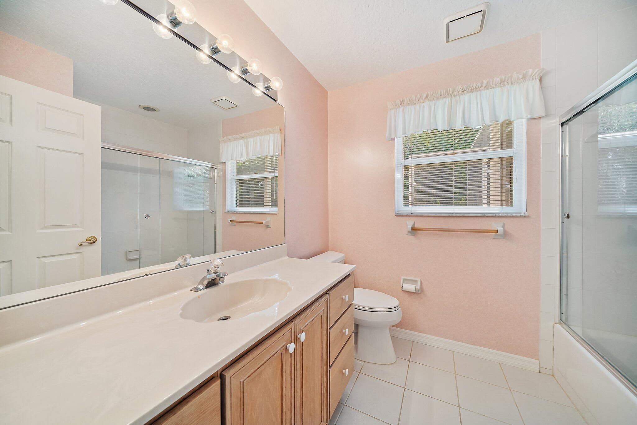 10424 Sandy Run Road Jupiter, FL 33478 - Photo 23 of 52 a bathroom with a double vanity sink toilet and a mirror