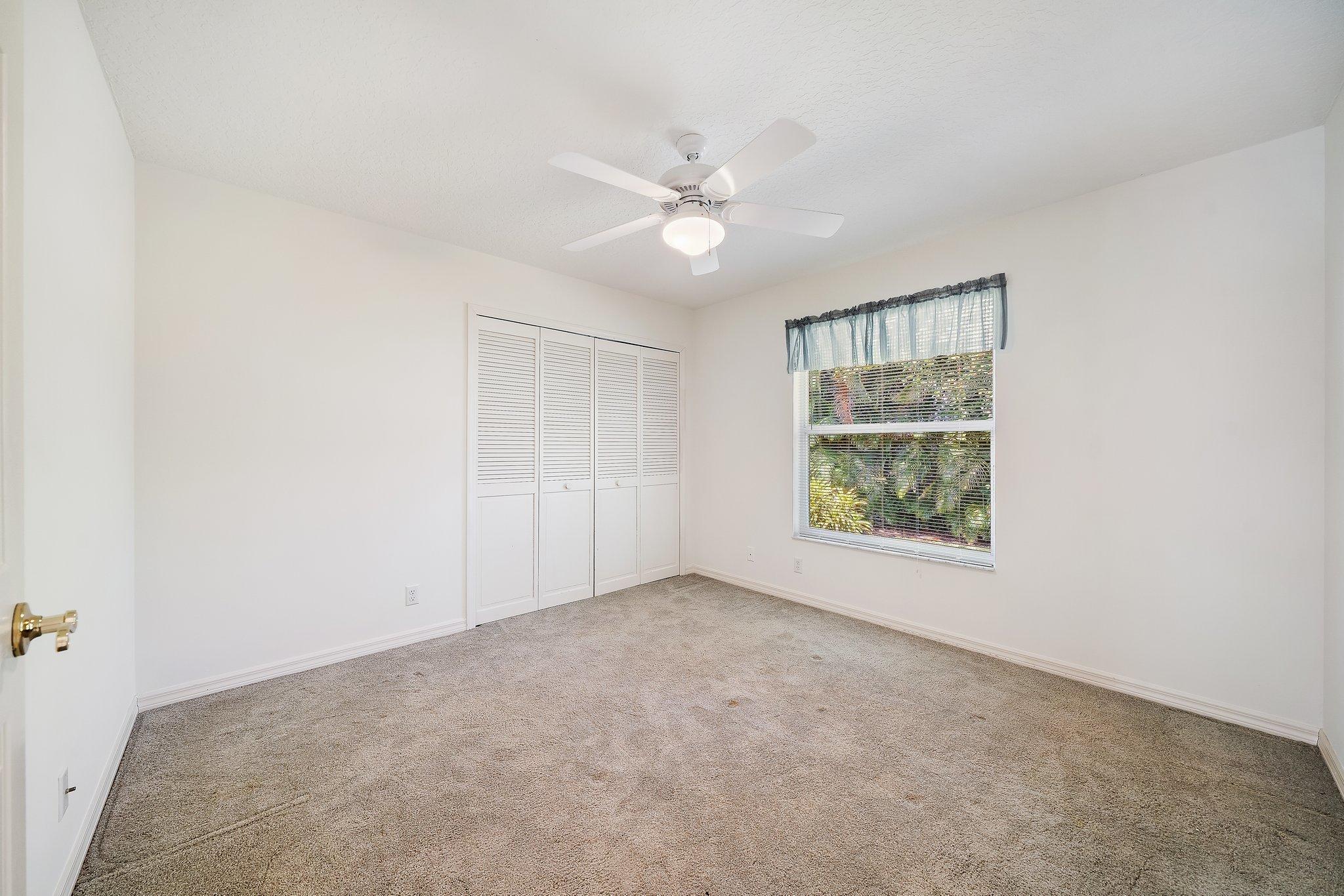10424 Sandy Run Road Jupiter, FL 33478 - Photo 26 of 52 an empty room with windows and fan
