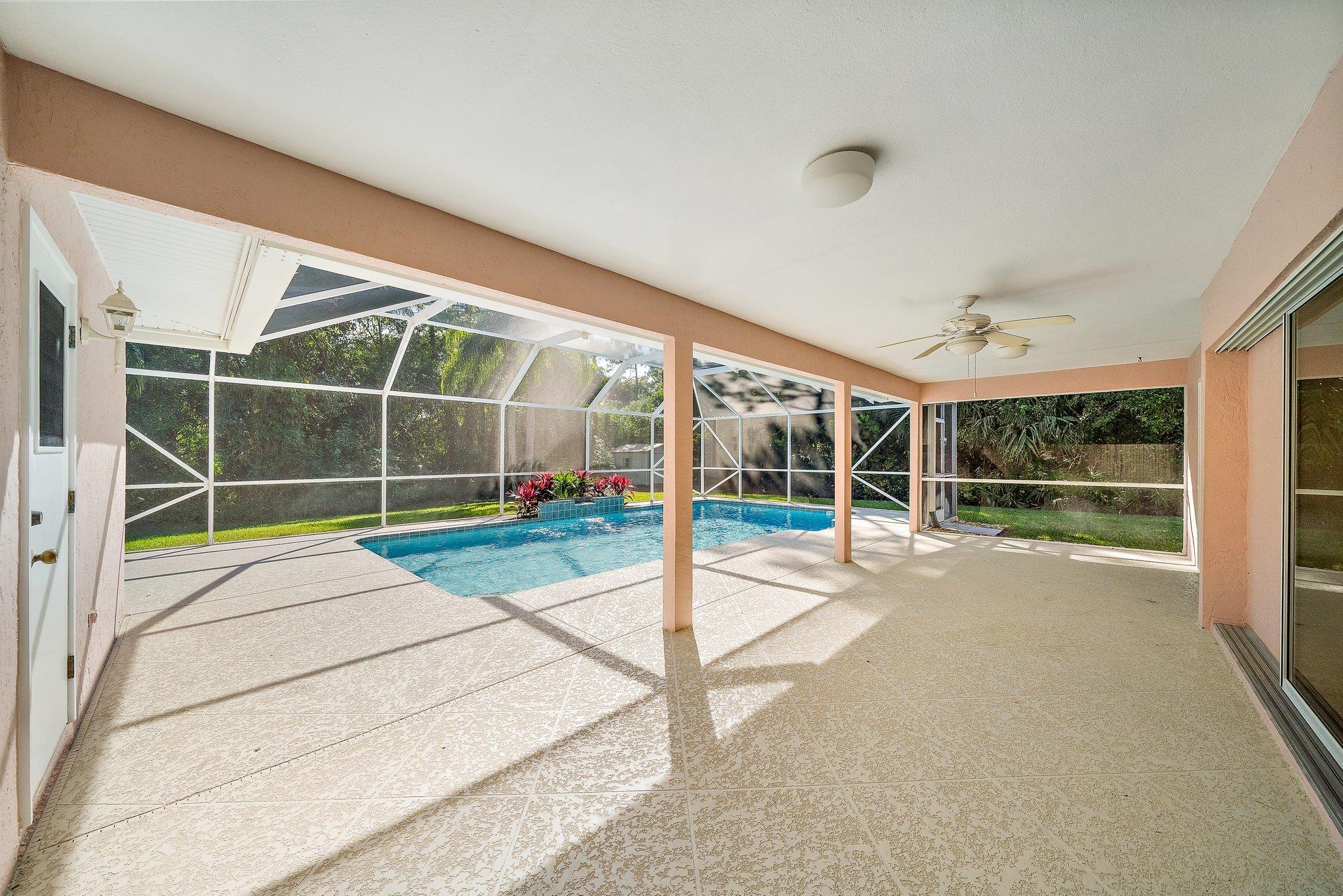 10424 Sandy Run Road Jupiter, FL 33478 - Photo 29 of 52 a view of an empty room with wooden floor and windows
