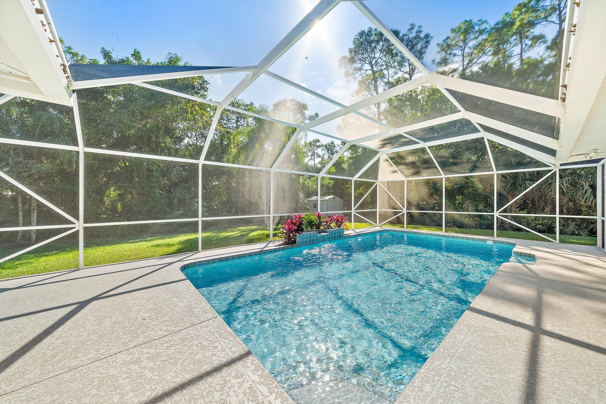 10424 Sandy Run Road Jupiter, FL 33478 - Photo 32 of 52 a view of a backyard with table and chairs