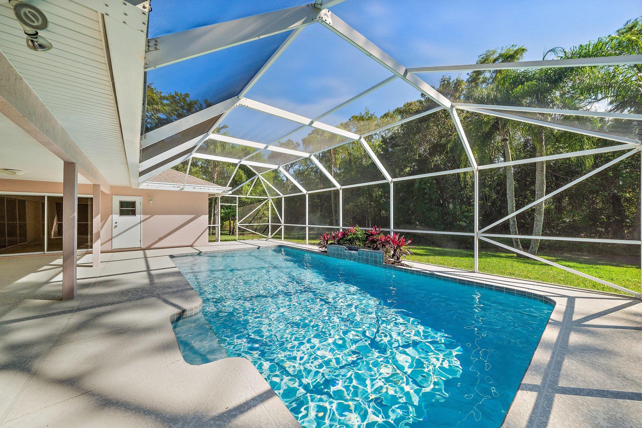 10424 Sandy Run Road Jupiter, FL 33478 - Photo 33 of 52 a view of a backyard with swimming pool