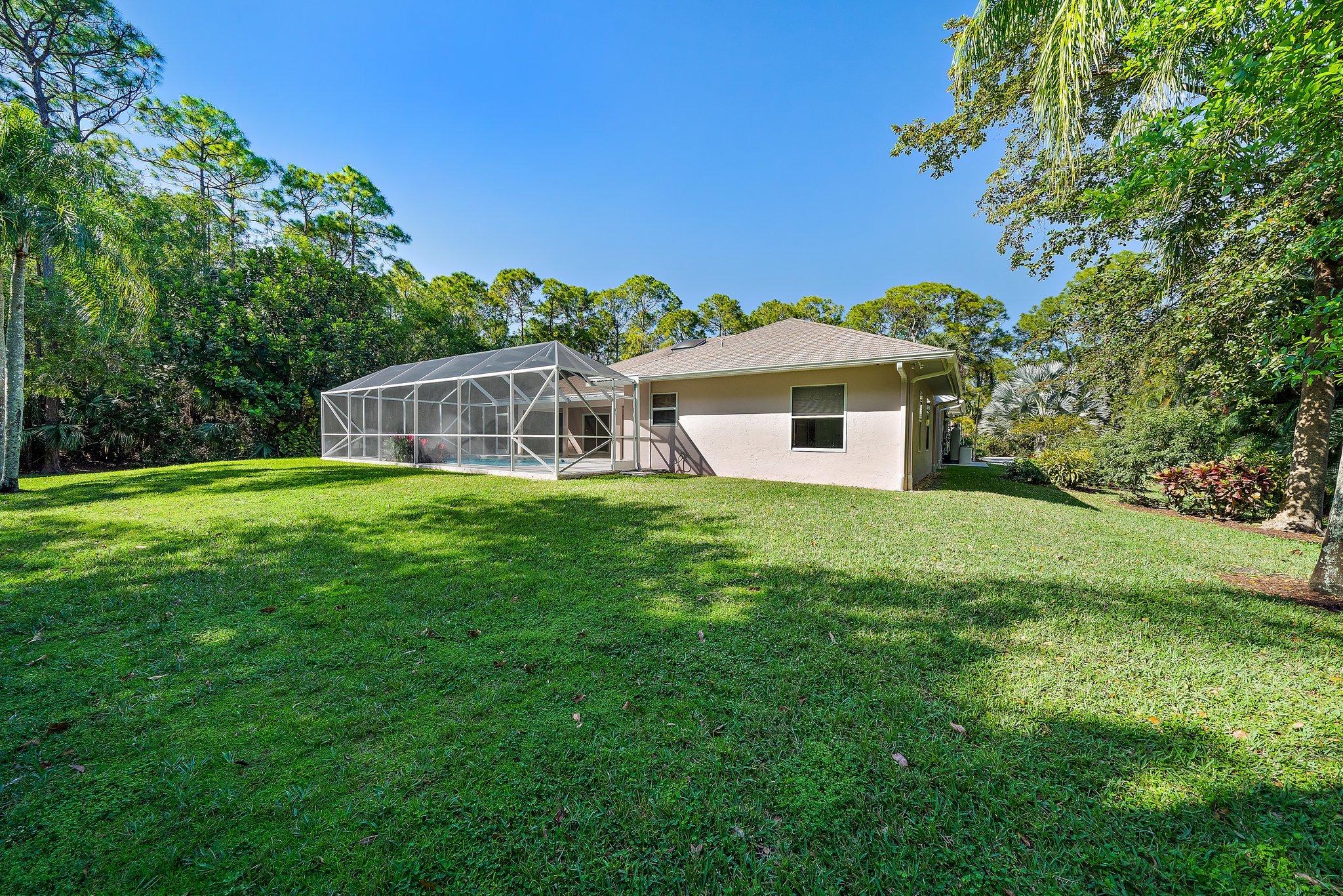 10424 Sandy Run Road Jupiter, FL 33478 - Photo 35 of 52 a front view of a house with yard and green space