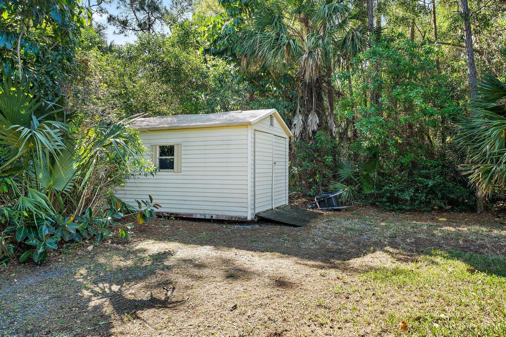 10424 Sandy Run Road Jupiter, FL 33478 - Photo 36 of 52 a view of a house with a yard