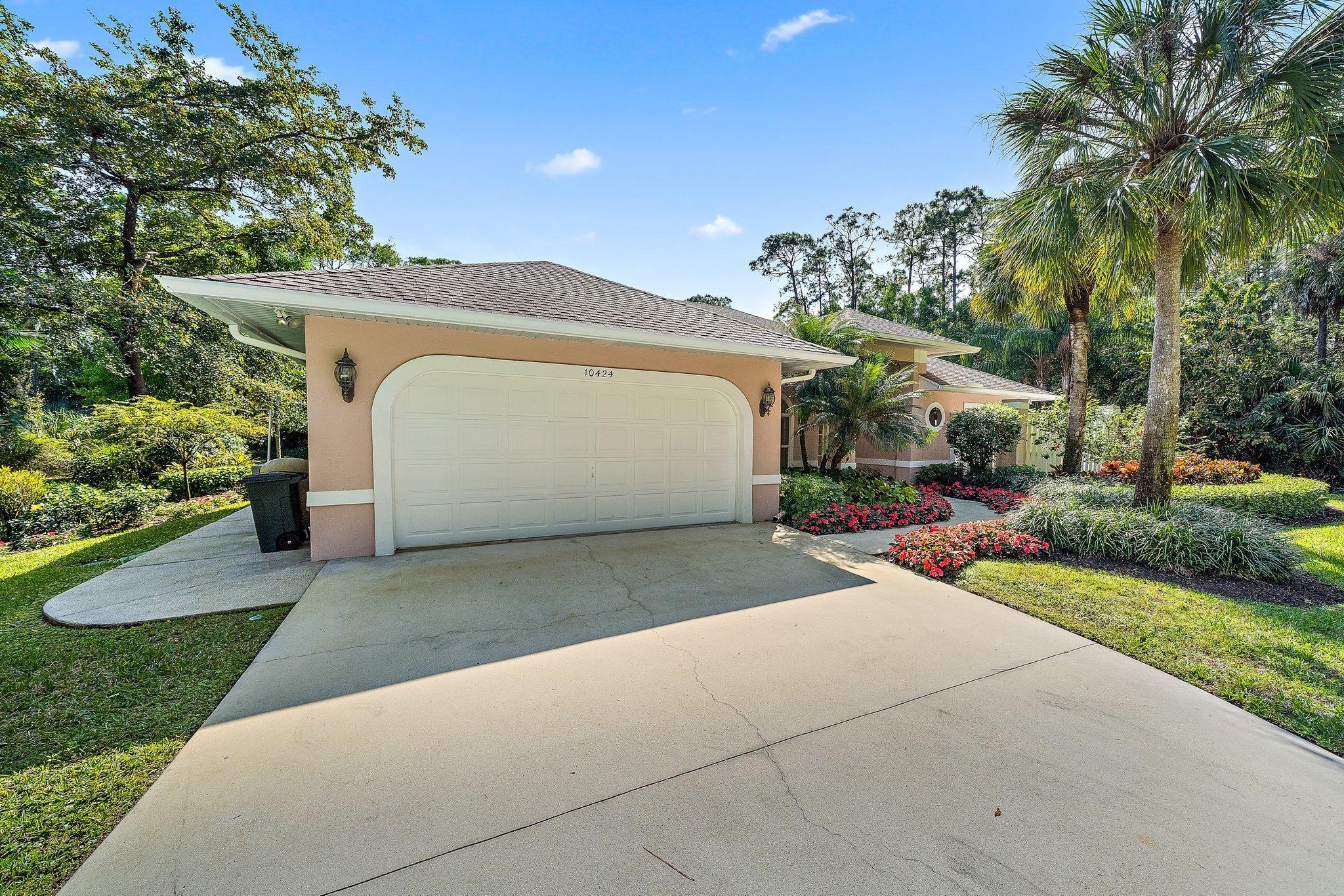 10424 Sandy Run Road Jupiter, FL 33478 - Photo 39 of 52 a view of a house with a yard and potted plants