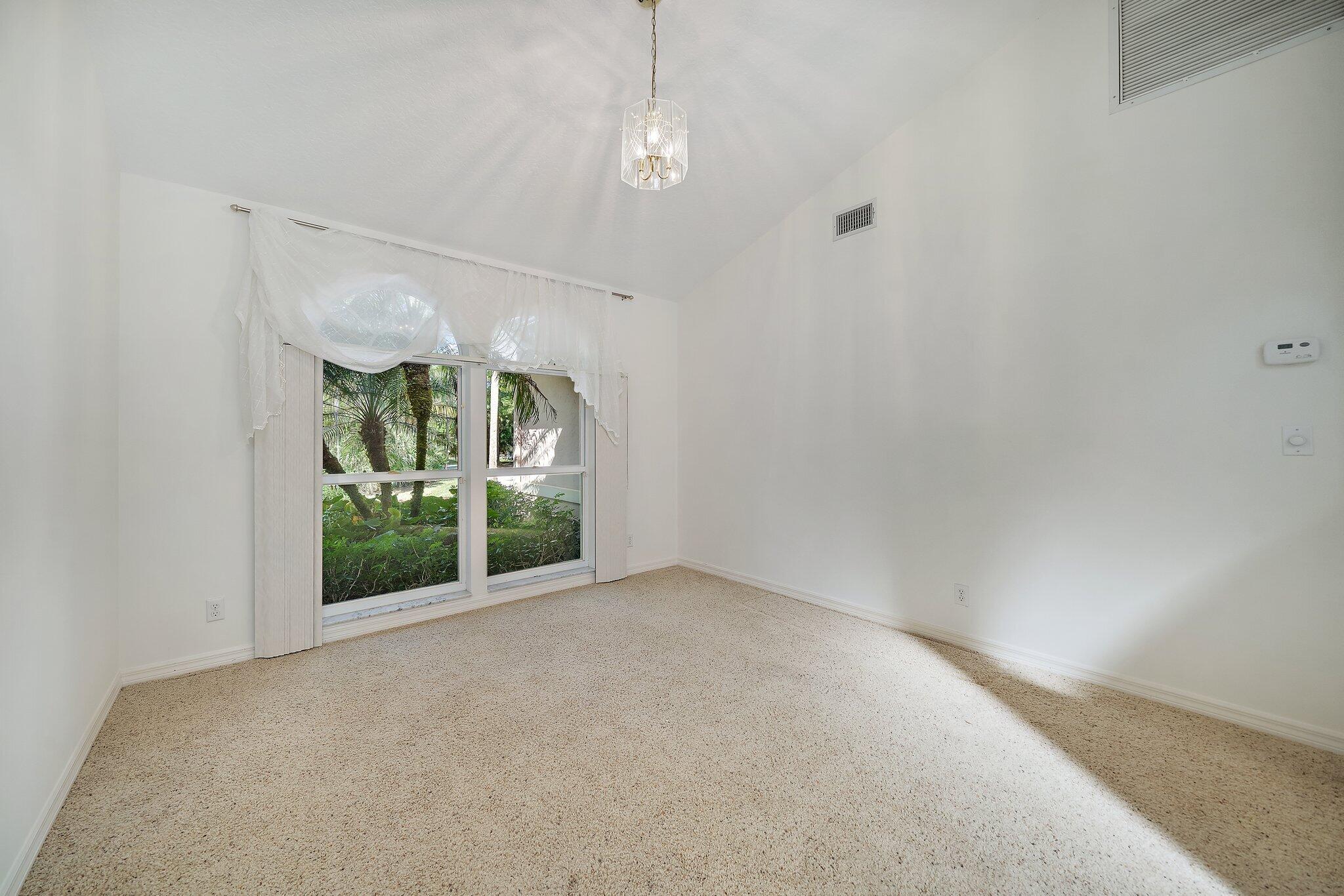 10424 Sandy Run Road Jupiter, FL 33478 - Photo 5 of 52 an empty room with windows