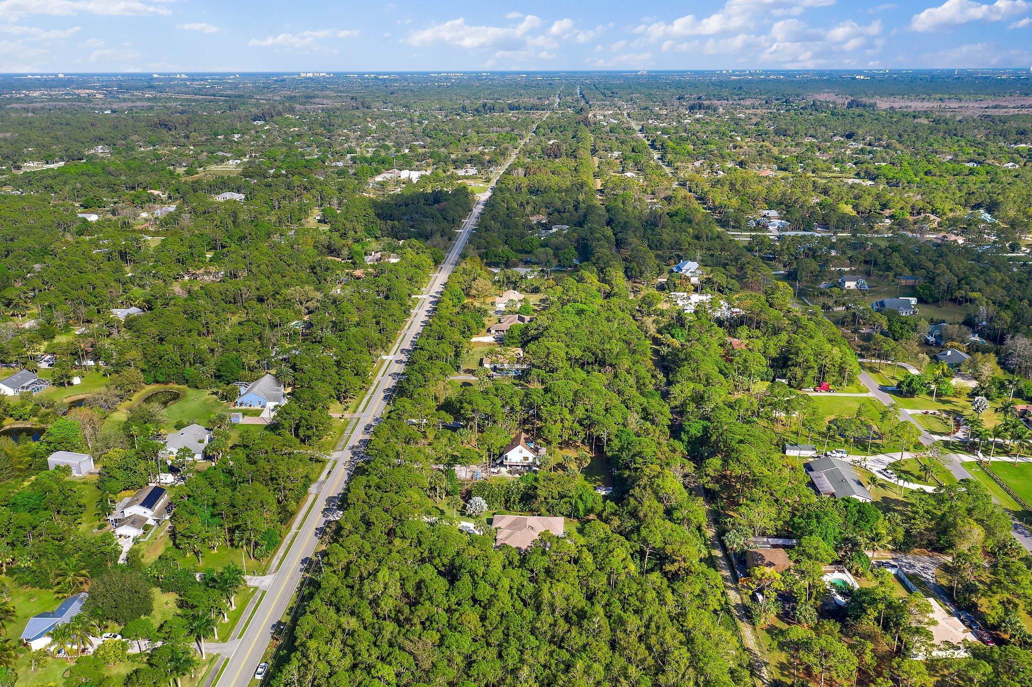 10424 Sandy Run Road Jupiter, FL 33478 - Photo 47 of 52 a view of a lush green field with lots of bushes